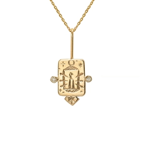 Detailed close-up of a gold tarot pendant featuring moon, star, and candle motifs with zircons