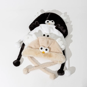 Cute bird-themed plush trapper hat with wings and eyes in black, white and beige colors