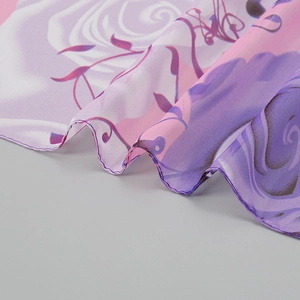 Detailed view of peony floral print on purple chiffon scarf with rolled hem edges