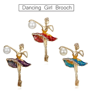 Detailed view of three enamel ballet dancer brooches with rhinestones and large pearls
