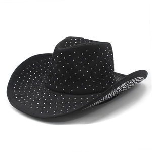 Detail of black suede cowboy hat featuring rhinestones and a Y2K western style design