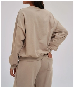 Detail view of the oatmeal-colored oversized sweatshirt and jogger pants from the back