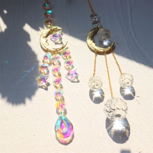Detailed view of crystal suncatcher pendants with golden crescent moon and rainbow prisms