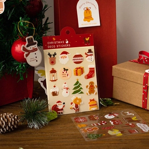 Christmas deco stickers with Santa and reindeer on gift boxes in festive holiday scene