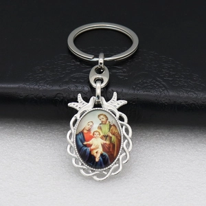 Detailed view of Holy Family religious pendant with decorative silver metal frame