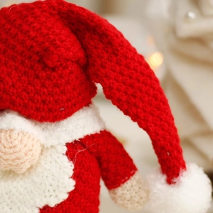 Nordic knitted Santa gnome doll with intricate red and white wool texture for Xmas decor
