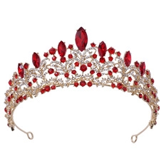 Detailed macro view of baroque gold tiara with sparkling red marquise gems and crystals