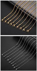 Detail view of gold and silver stainless steel snake chains with lobster clasps on leather