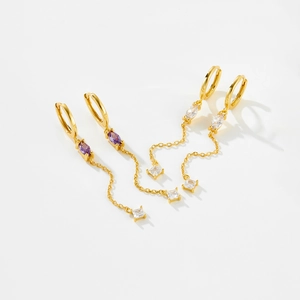 Detail of S925 silver long chain earrings with purple marquise zircon and gold finish