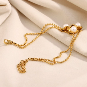 Elegant 18K gold plated beaded chain bracelet featuring three pearl flower charms