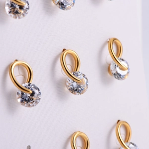 Elegant gold zircon stud earrings with sparkling round crystal on white card