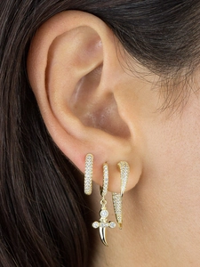 Detailed close-up of zircon studded gold earring set featuring dagger and crescent spike charms