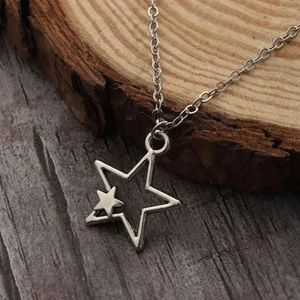 Hip hop silver star pendant necklace for men displayed on a rustic wooden texture