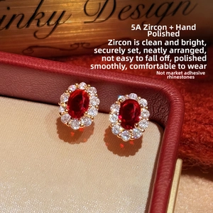 Macro view of 18K gold plated oval red zircon earrings with 5A grade white stone halo