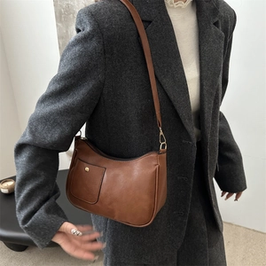 Classic brown rectangular shoulder bag in premium PU leather shown on a model