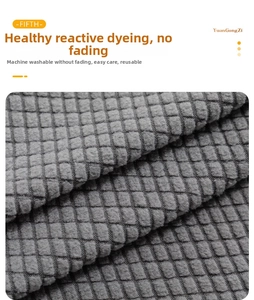 Close-up of grey jacquard stretch chair cover fabric showing a textured square pattern