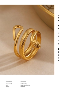 Macro shot of gold-plated snake ring with triple spiral design and detailed scale textures
