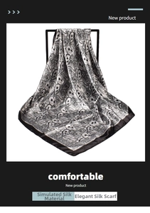 Close-up of black and white paisley satin scarf showing silky texture and draped pattern