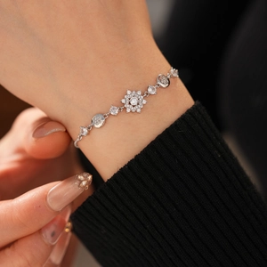 Close-up of elegant silver snowflake bracelet with sparkling zircon stones on a wrist
