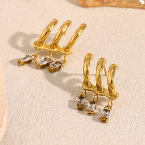 Macro view of 18K gold plated tassel earrings with rectangular cubic zirconia