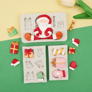 Macro detail of grey silicone Christmas molds featuring Santa and gift box designs