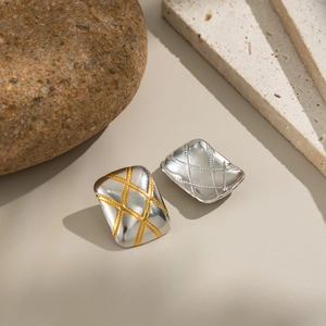 Two-tone rectangular gold and silver stud earrings featuring a textured diamond pattern