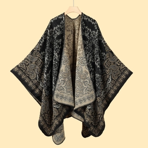 Detail of knit shawl featuring double-sided black and beige paisley floral patterns