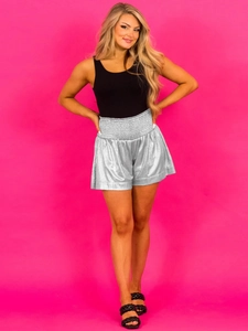 Metallic silver high-waisted shorts with elastic waist and wide-leg fit for casual sport