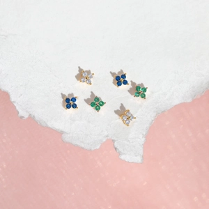 Set of six minimalist gold flower stud earrings with blue green and white crystals