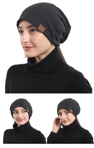 Detailed views of a black cotton beanie with a brown F&S leather tag and soft texture