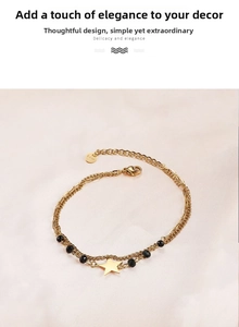 Close-up of gold-plated double-layer bracelet with black beads and a star pendant