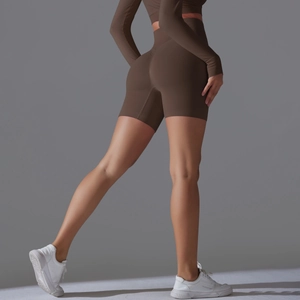 Detail view of high-waist seamless brown yoga shorts with peach-lift and shaping effect