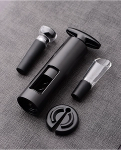 Macro view of a 4-piece wine opener set with aerator and stopper on gray fabric