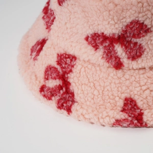 Pink lamb wool bucket hat with red bow jacquard pattern for winter warmth