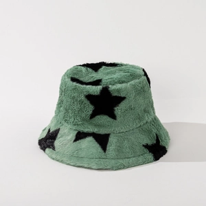 Detailed view of green plush bucket hat with black stars and soft faux fur texture