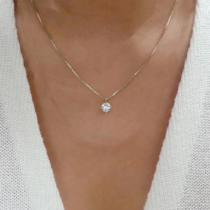Detail of a sparkling round zircon pendant on a fine S925 sterling silver chain necklace