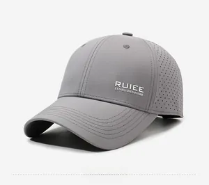 Detail of grey baseball cap featuring laser-cut ventilation holes and white logo text
