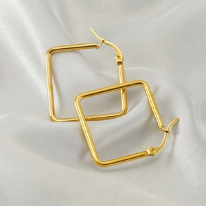 Minimalist square hollow gold earrings made of polished stainless steel on silk