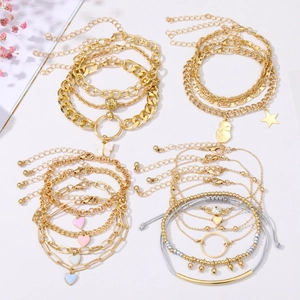 Detail of vintage multilayer bracelet set with gold and silver butterfly and star charms