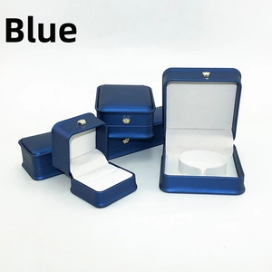 Detail of blue jewelry gift box collection with gold crown icons and white velvet lining