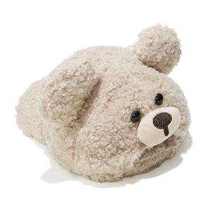 Detail of plush lamb wool fabric and cute bear face embroidery on a cozy beige winter cap