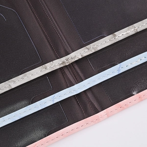 Detailed close-up showing fine stitching and marble pattern edges on a PU passport holder