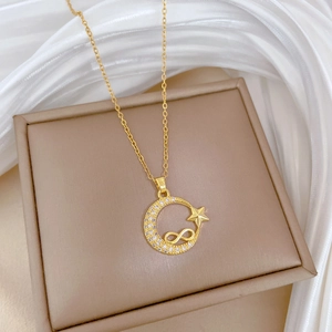 Elegant gold celestial necklace featuring crescent moon, star, and infinity symbol with crystals