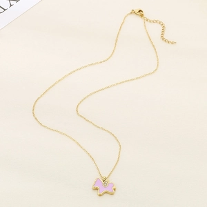 Golden titanium unicorn necklace with pink enamel and diamond accents on plain background