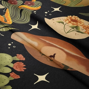 Detailed view of desert starry night tapestry fabric with cactus and celestial patterns