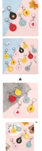 Detail showing various colorful PU leather access card holders with 3D fruit cartoon charms