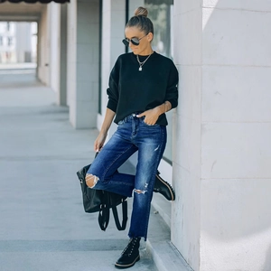 Dames high waist jeans met gaten in donkerblauw met een zwart sweatshirt met lange mouwen