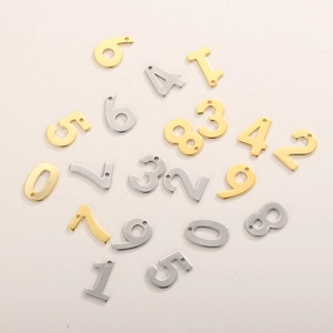 Detailed view of polished gold and silver numbered 0-9 pendants for DIY jewelry crafting