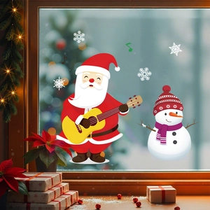 Christmas window stickers featuring Santa playing guitar and snowman on a glass window