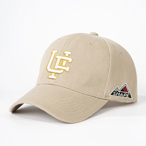 Detailed view of the yellow UC embroidery on a beige adjustable cotton baseball cap